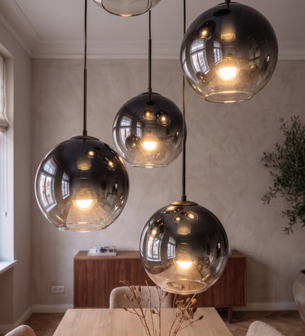 Cielo pendant light close-up: glowing black-to-chrome glass globes
