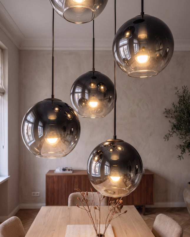 Cielo pendant light close-up: glowing black-to-chrome glass globes