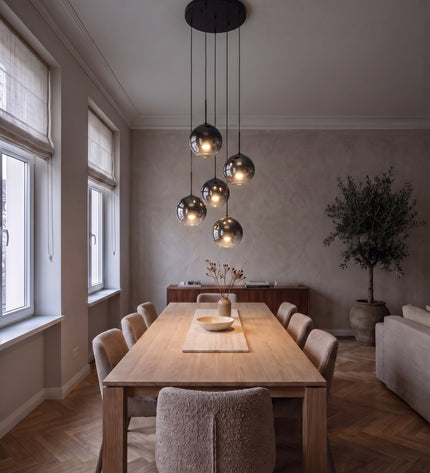 Cielo cluster pendant light with six black-to-chrome glass globes above a dining table