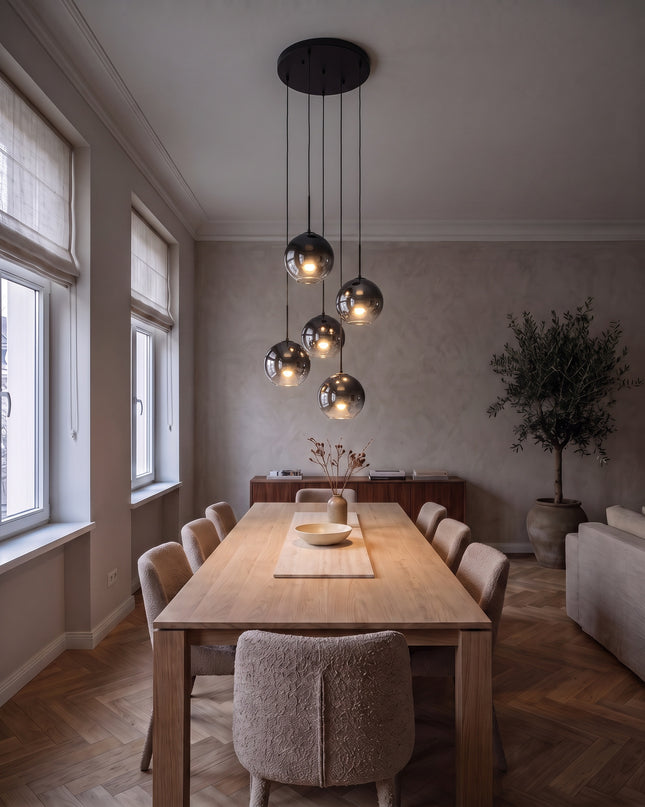 Cielo cluster pendant light with six black-to-chrome glass globes above a dining table