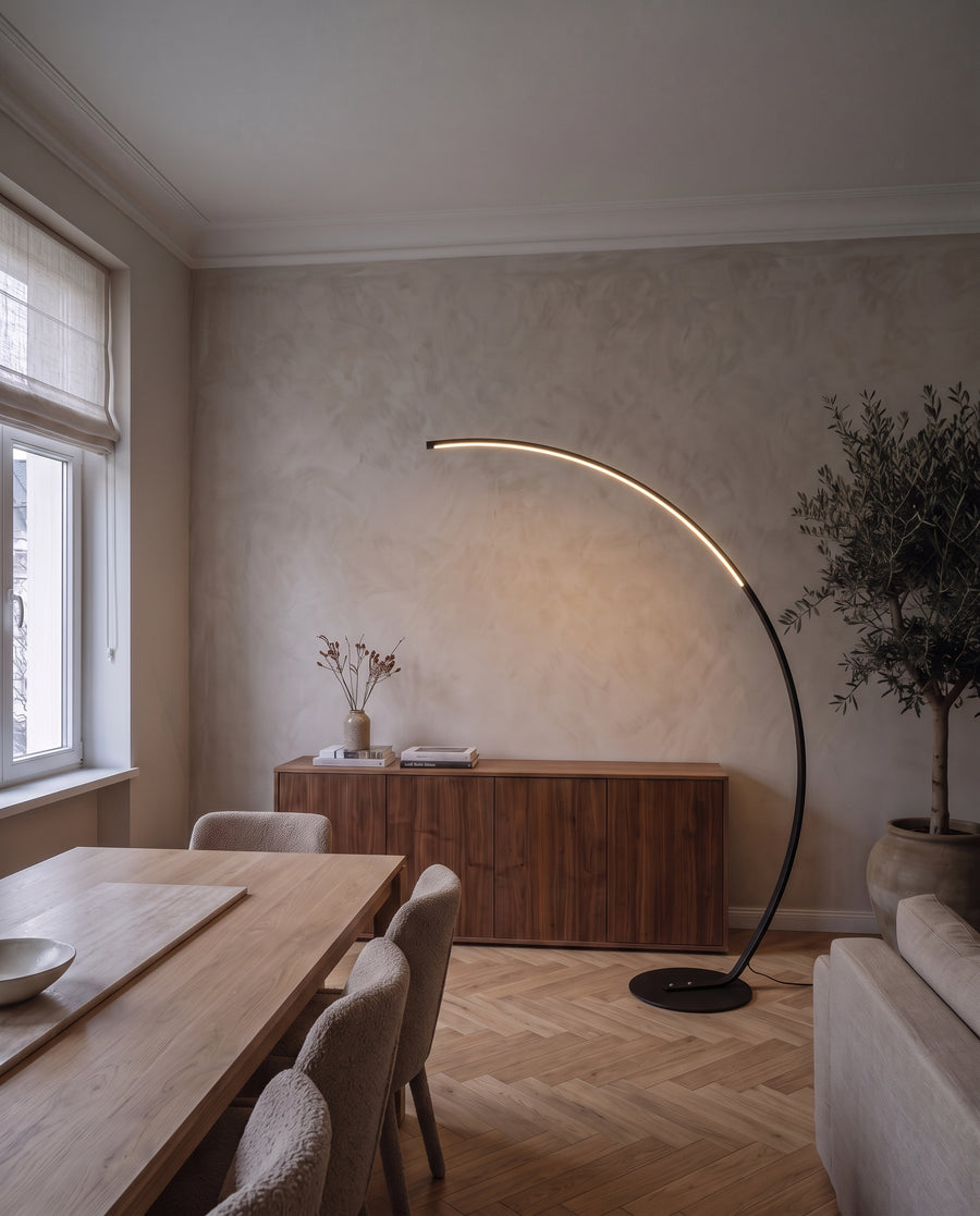 Arco floor lamp lighting the coffee table in a living room