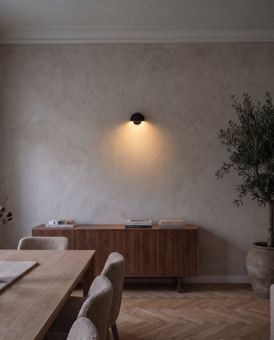 Cupola wall light casting soft light on a living room wall
