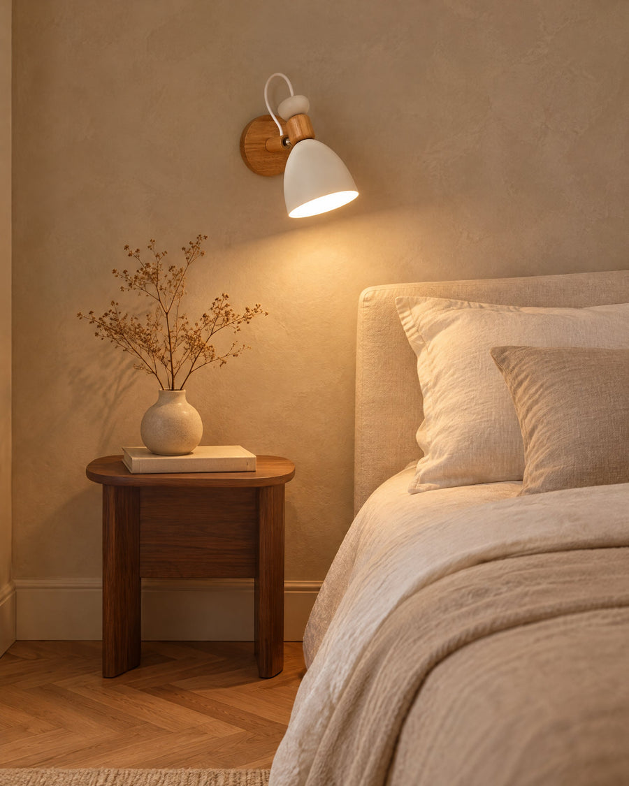 Berlin wall lamp in white in a bedroom next to the bed