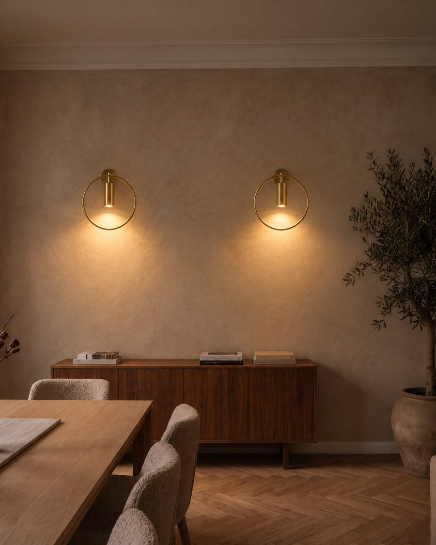 Two bronze Casoria wall lights above a sideboard in the dining room