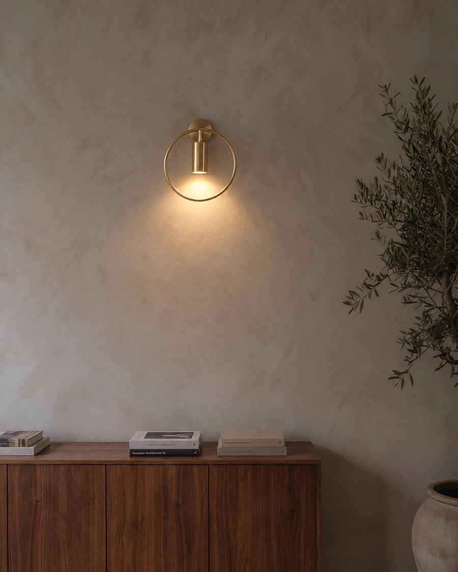 Casoria wall light in bronze on a lime plaster wall