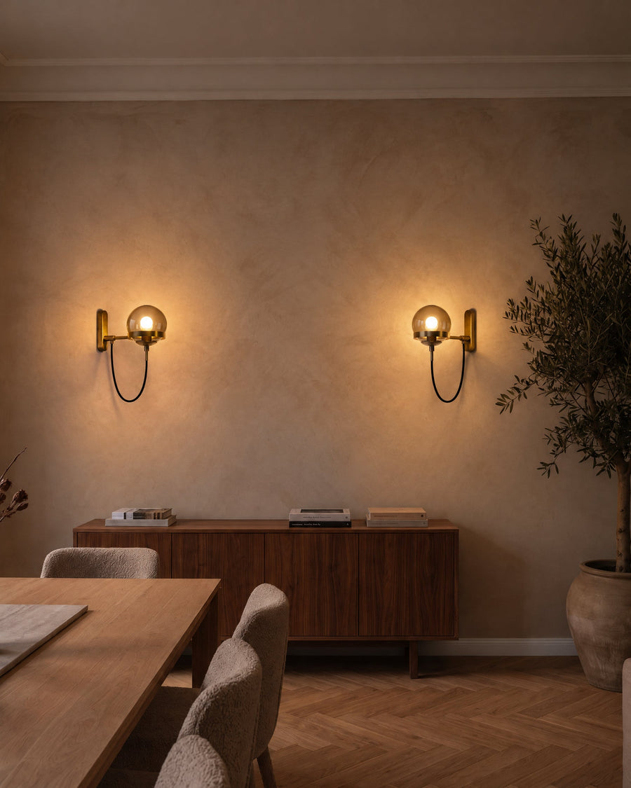 A pair of Strasbourg wall lights above the sideboard in the dining room