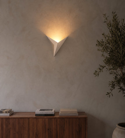 Aurelia wall light in white on a lime plaster wall