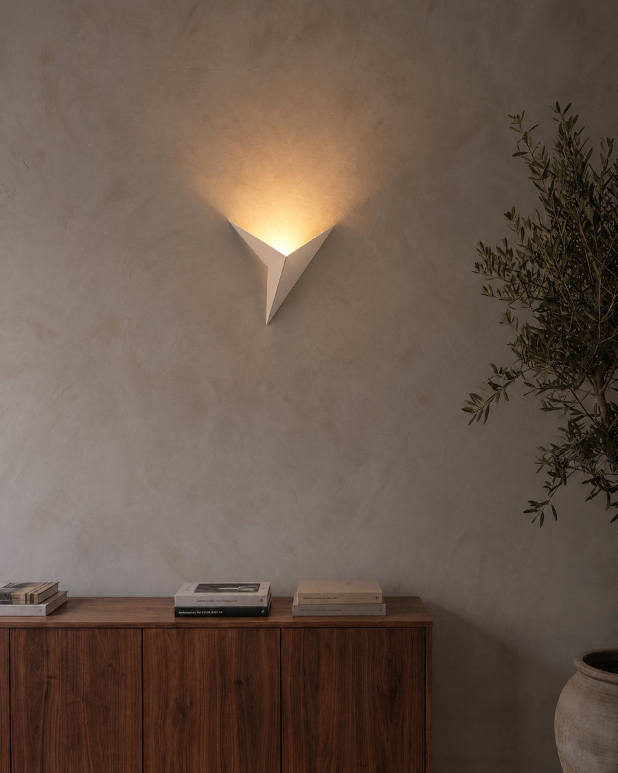 Aurelia wall light in white on a lime plaster wall