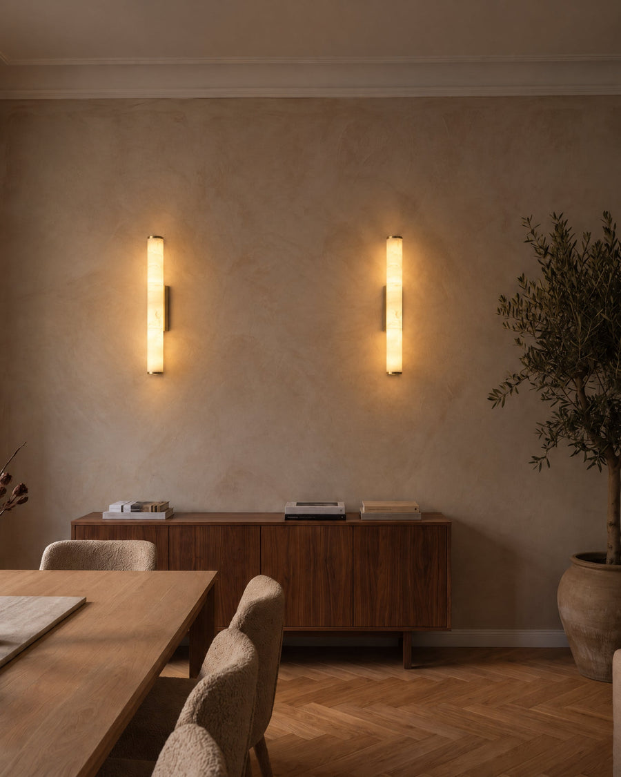 A pair of Klyr wall lights above a sideboard in a dining room