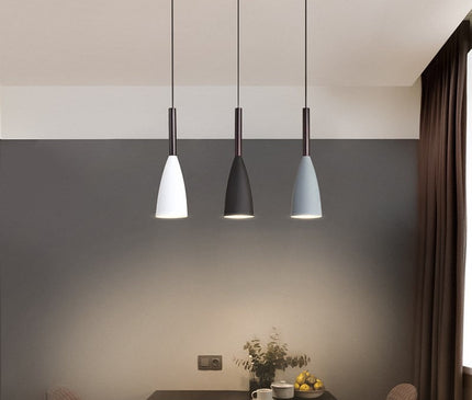 Black Monaco pendant light by Kezaro with a sleek, modern design, hanging from a ceiling fixture.