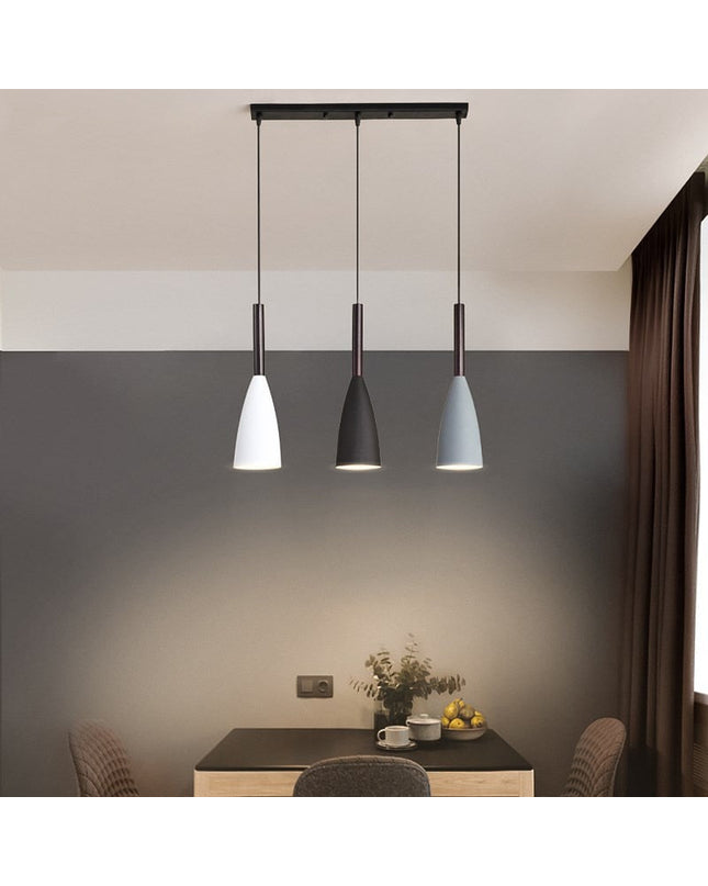 Black Monaco pendant light by Kezaro with a sleek, modern design, hanging from a ceiling fixture.
