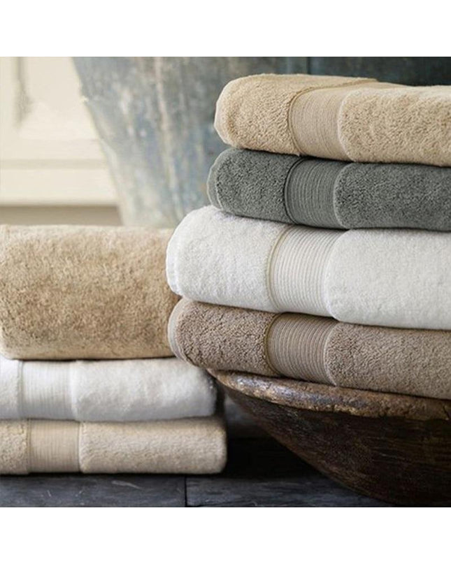 Kezaro Sonnel cotton towel in green, soft and plush with intricate woven pattern, ideal for luxurious bathroom use.