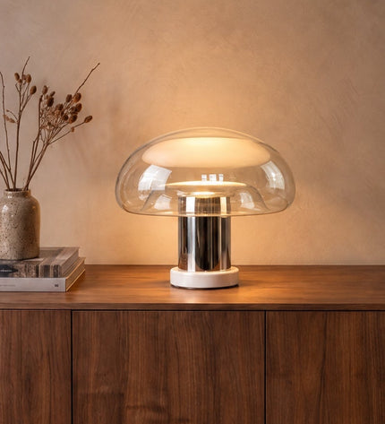 Nebbia glass mushroom table lamp with chrome stem on a walnut sideboard