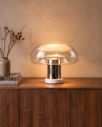 Nebbia glass mushroom table lamp with chrome stem on a walnut sideboard
