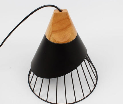 Black Bordeaux pendant light by Kezaro with a sleek, minimalist design hanging from the ceiling.