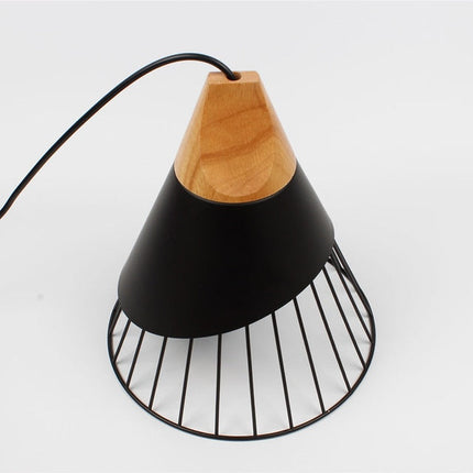 Black Bordeaux pendant light by Kezaro with a sleek, minimalist design hanging from the ceiling.