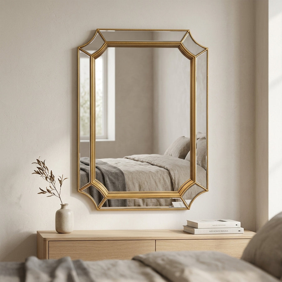 Mira wall mirror in gold in a bedroom