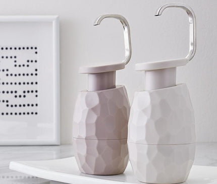 Kezaro warm gray one-handed soap dispenser with sleek modern design and easy-to-use pump for bathroom or kitchen use.