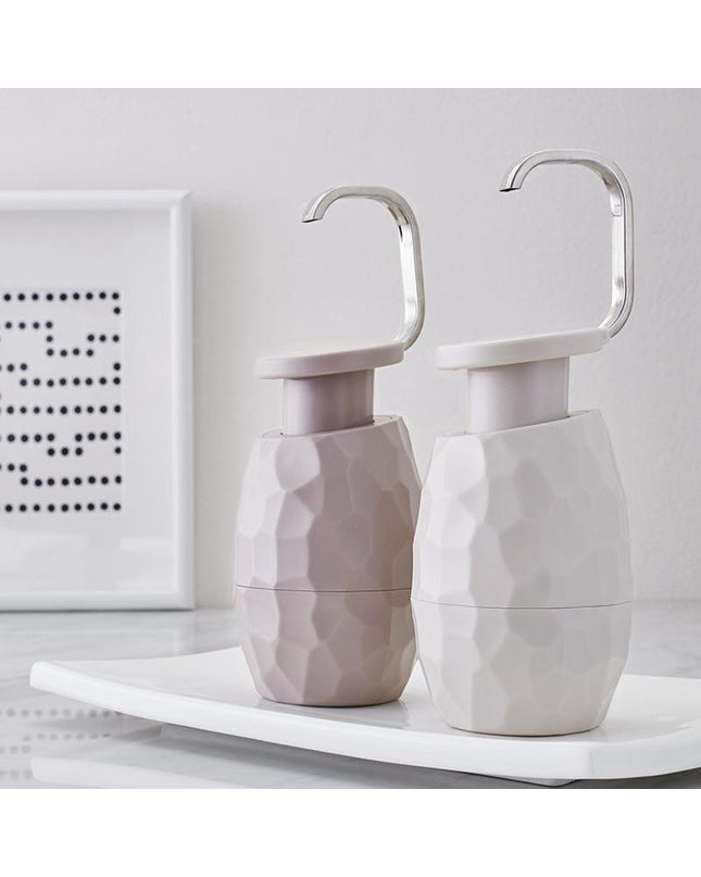 Kezaro warm gray one-handed soap dispenser with sleek modern design and easy-to-use pump for bathroom or kitchen use.