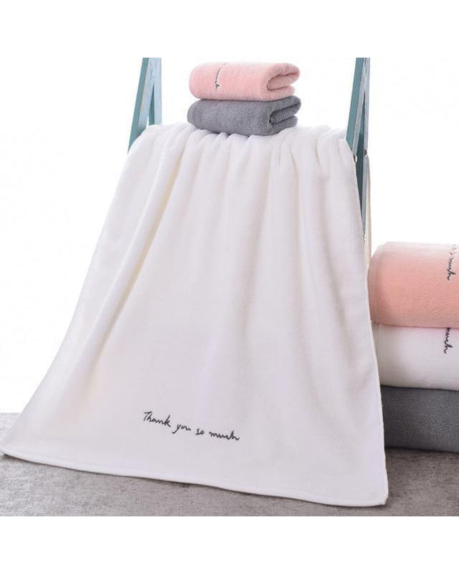 White Tina cotton hand towel by Kezaro, soft and absorbent, with a terry cloth texture and decorative border.