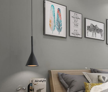 White Toulon pendant light by Kezaro with a modern, sleek design hanging from the ceiling.