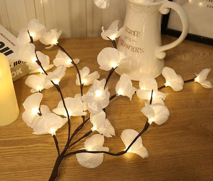 White orchid branch light by Kezaro, decorative orchid stem with LED lights for home decor or floral arrangements.