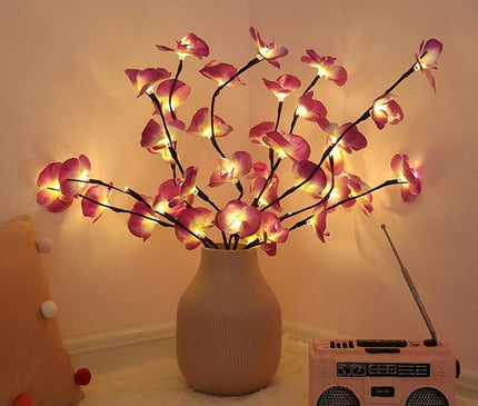 White orchid branch with LED lights from Kezaro, decorative artificial orchid stem for home or event décor.