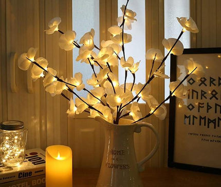 White orchid branch light from Kezaro with delicate orchid flowers and illuminated stems for decorative ambiance.