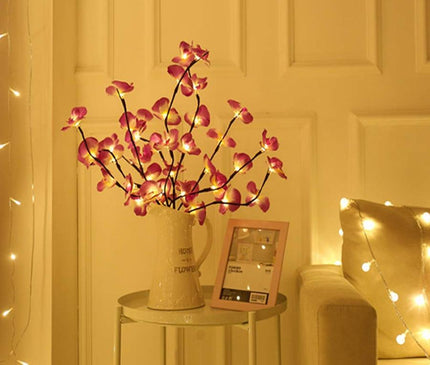 White orchid branch LED light by Kezaro, decorative artificial orchid with illuminated flowers for home decor.
