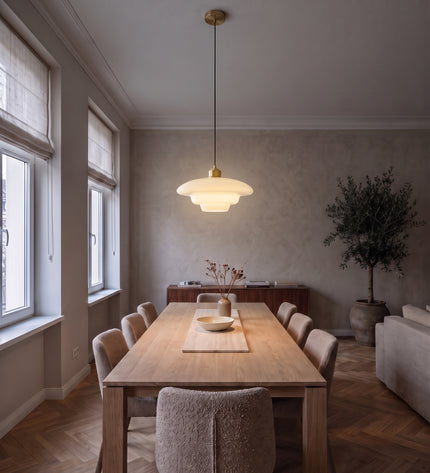 Latte opal glass pendant light, switched on above an oak dining table