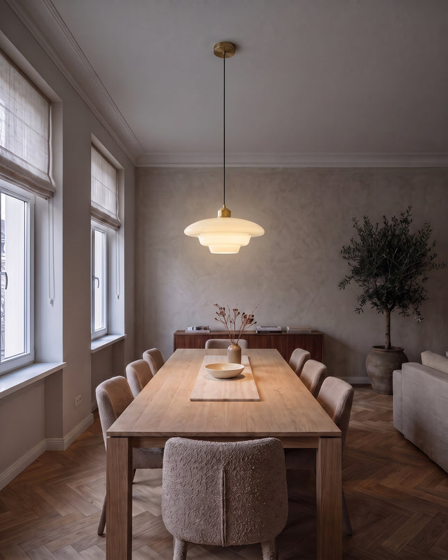 Latte opal glass pendant light, switched on above an oak dining table